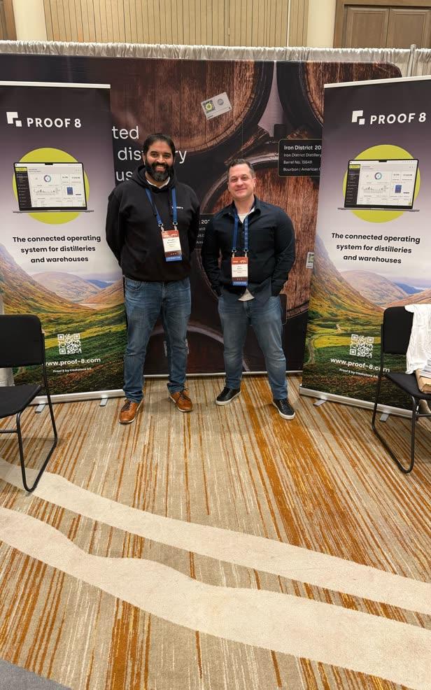 Proof 8 team at a trade show with branded pull-up banners