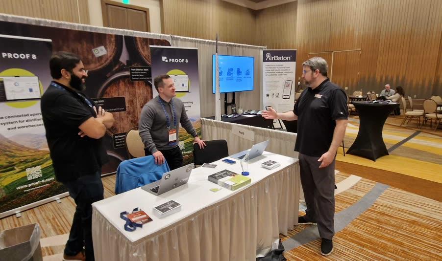 Proof 8 team speaking with a customer at a trade show booth